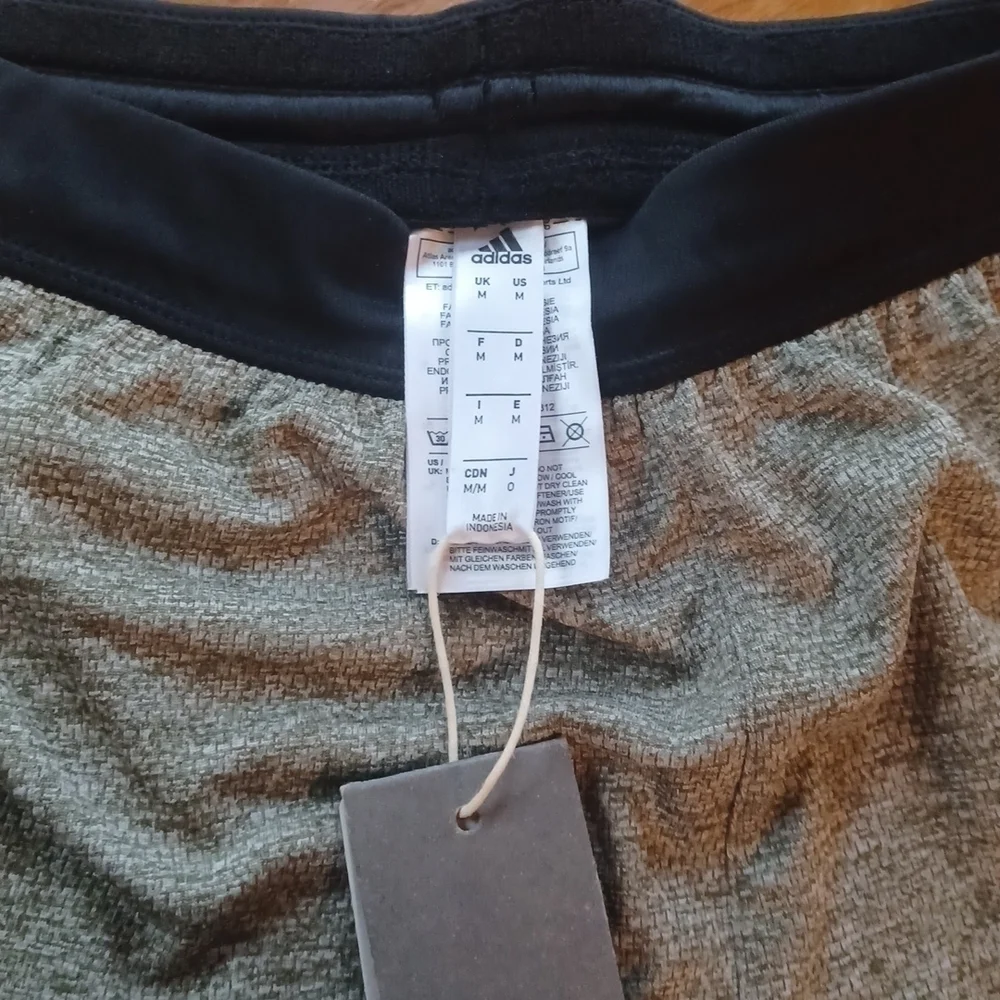 NWT   Adidas knit Grey shorts. Black waist band, white stripes. Size medium.